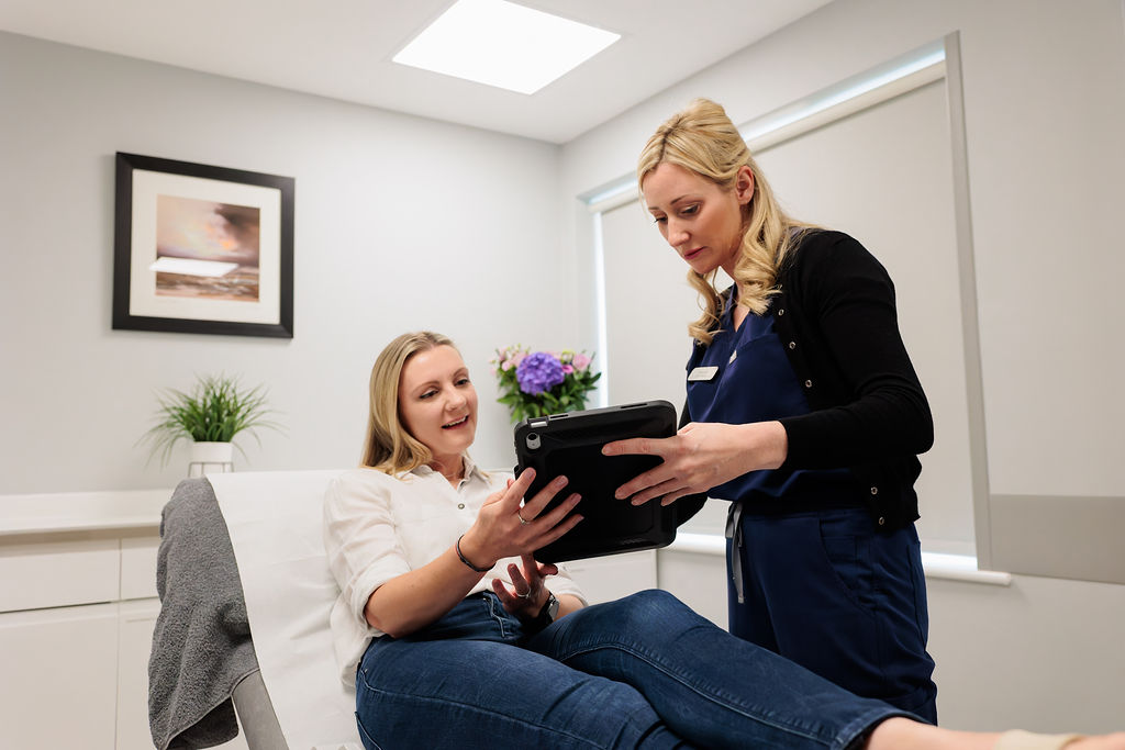 A specialist engaging in a discussion with a woman about Polynucleotide Treatment